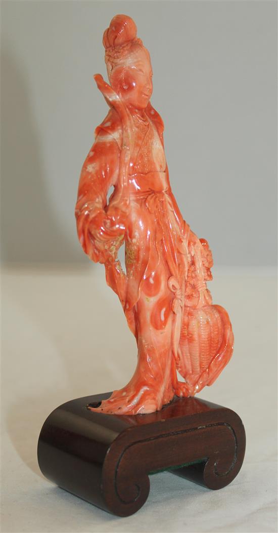 A Chinese coral figure of a beautiful lady holding a basket of flowers, 17.5cm incl. wood stand